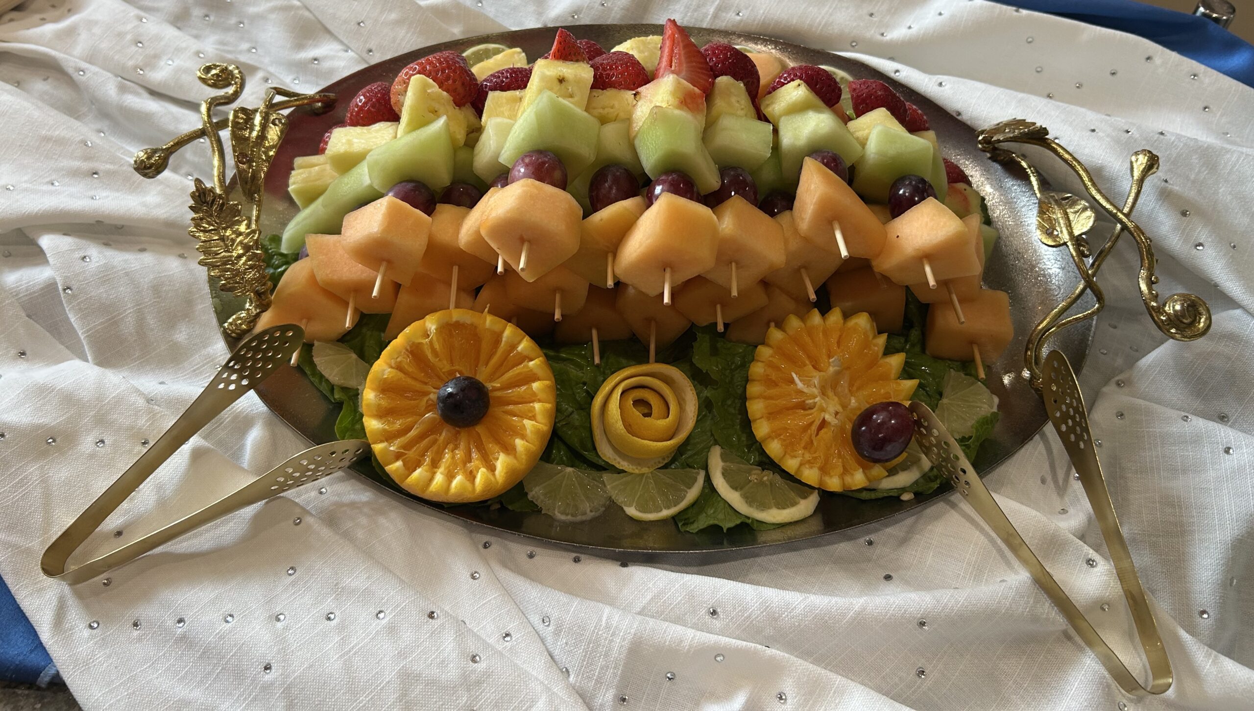 Fresh fruit platter with citrus garnish on a silver tray