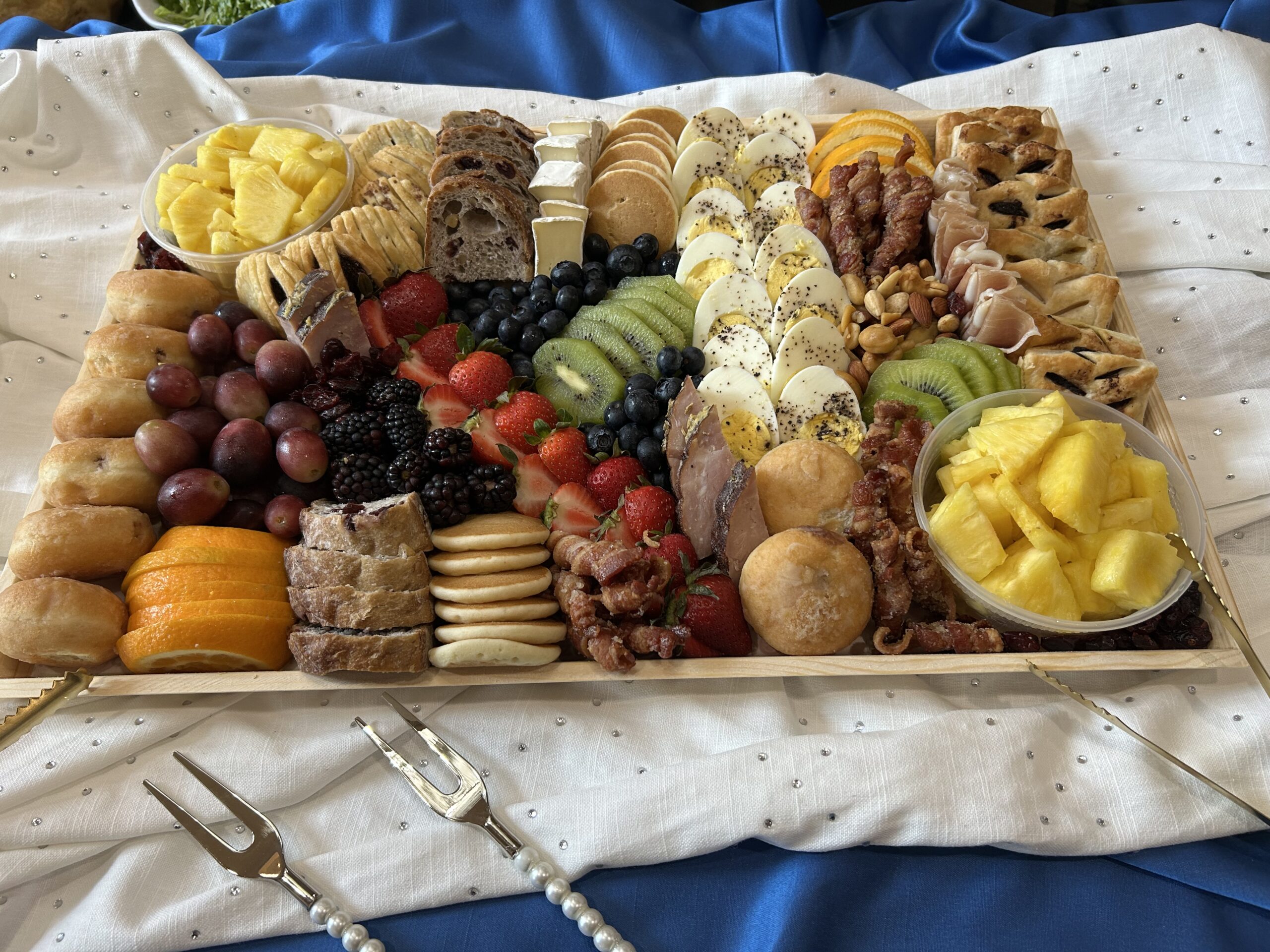 Breakfast grazing board with pastries, eggs and fruit
