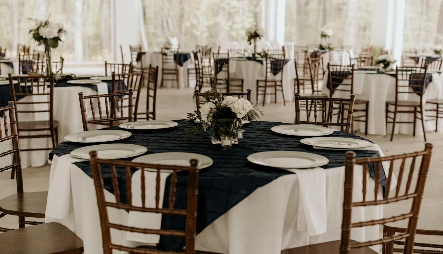 Round event tables with chiavari chairs and elegant linens
